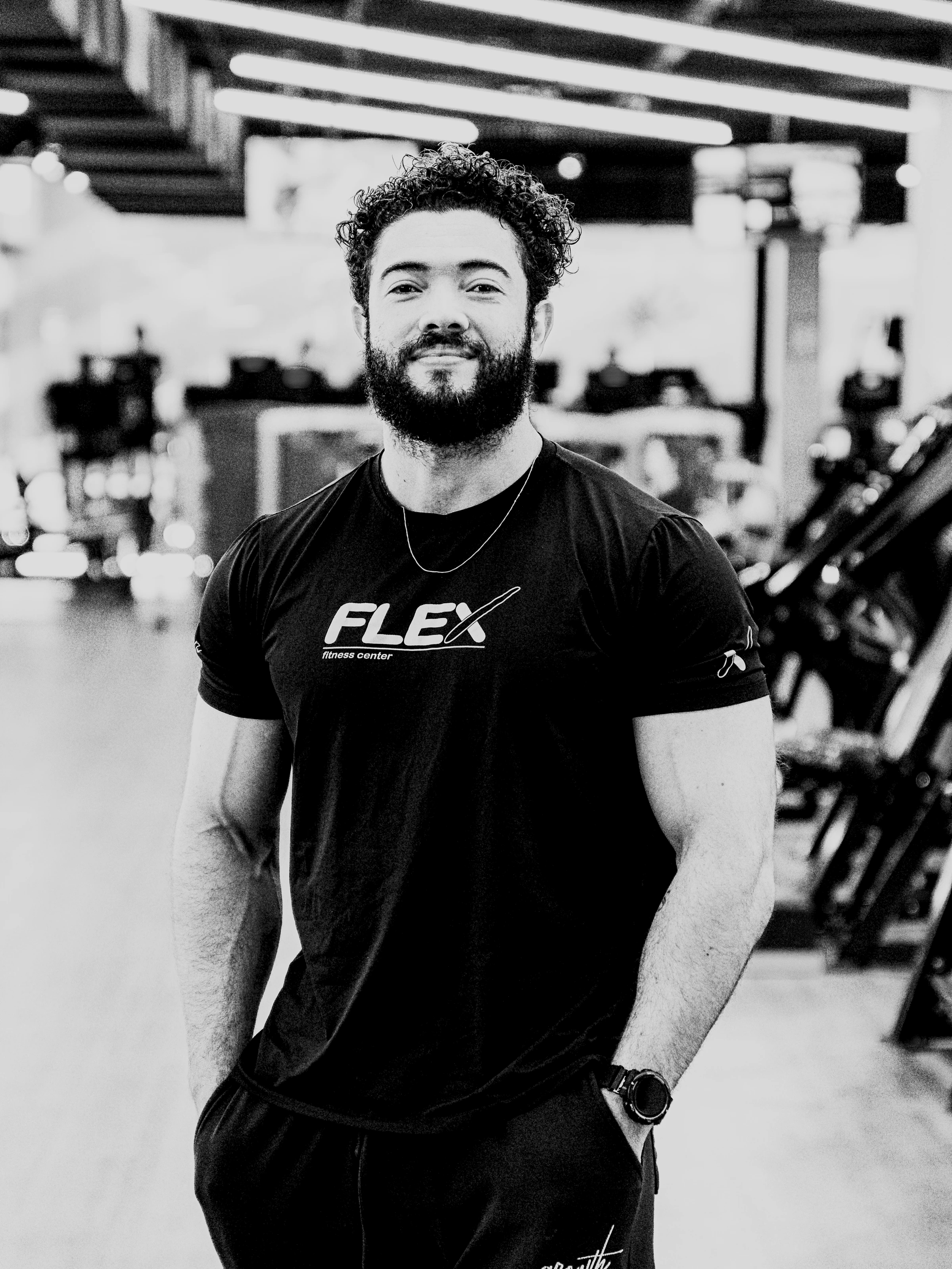 Wellisson de pé na Flex, em retrato preto e branco, com o visual atual